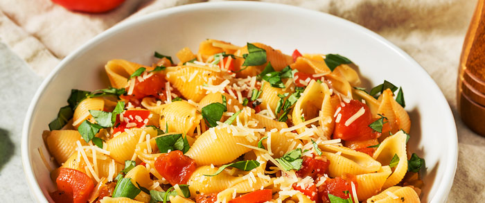 bowl of pasta salad with some cheese sprinkled on top