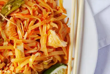 plate of Pad Thai noodles with chop sticks on a white plate
